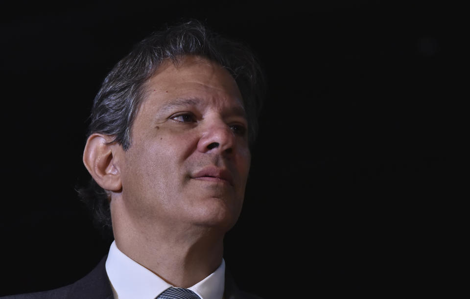 Former Sao Paulo Mayor Fernando Haddad listens to Brazil's President-elect Luiz Inacio Lula da Silva, during a press conference at Da Silva's transition team headquarters in Brasilia, Brazil, Friday, Dec.9 2022. Lula da Silva revealed on Friday some of the faces that will compose his future administration, starting Jan. 1, including his much-awaited pick for Finance Minister: Haddad. (AP Photo/Ton Molina)