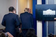 President Donald Trump is asked to leave the James Brady Press Briefing Room by a member of the U.S. Secret Service during a news conference at the White House, Monday, Aug. 10, 2020. (AP Photo/Andrew Harnik)