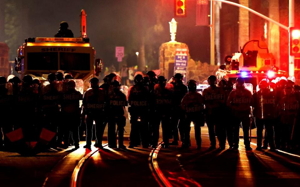 Several area law enforcement agencies stand at the intersection of University Boulevard and Park Avenue after ejecting a small group of pro-Palestinian demonstrators off the University of Arizona campus, Friday, May 10, 2024, Tucson, Az