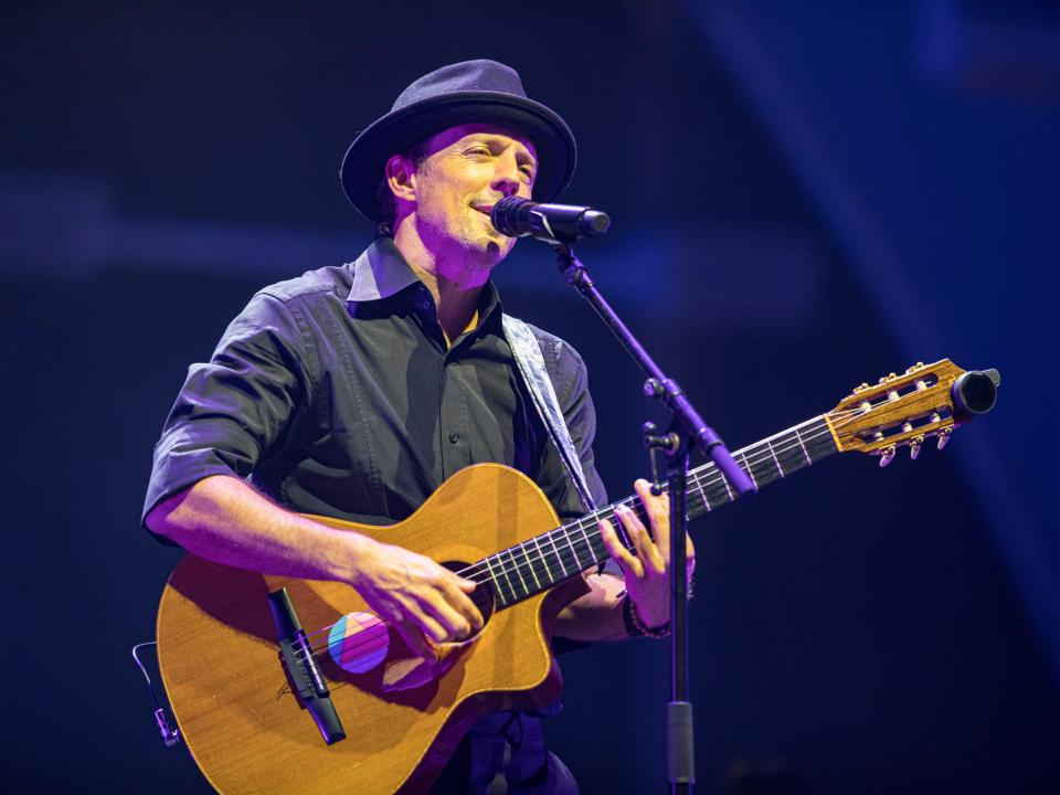 Jason singing and playing guitar on stage.