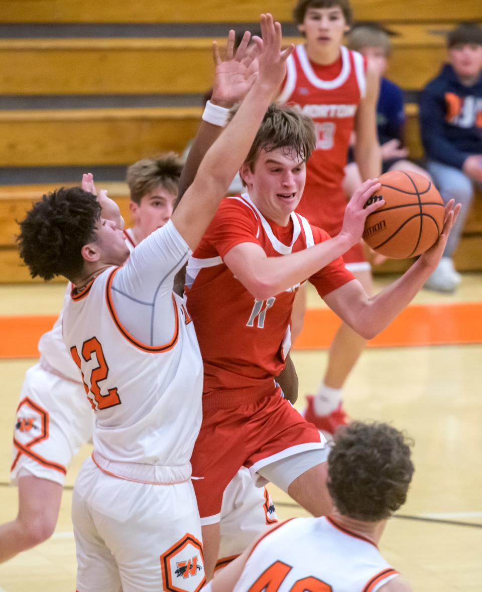 Morton's Gus Rugaard (11) looks to pass as Washington's James Johnson defends in the second half of their Mid-Illini Conference basketball game Tuesday, Feb. 13, 2024 at Washington Community High School. The Panthers fell to the Potters 51-39.