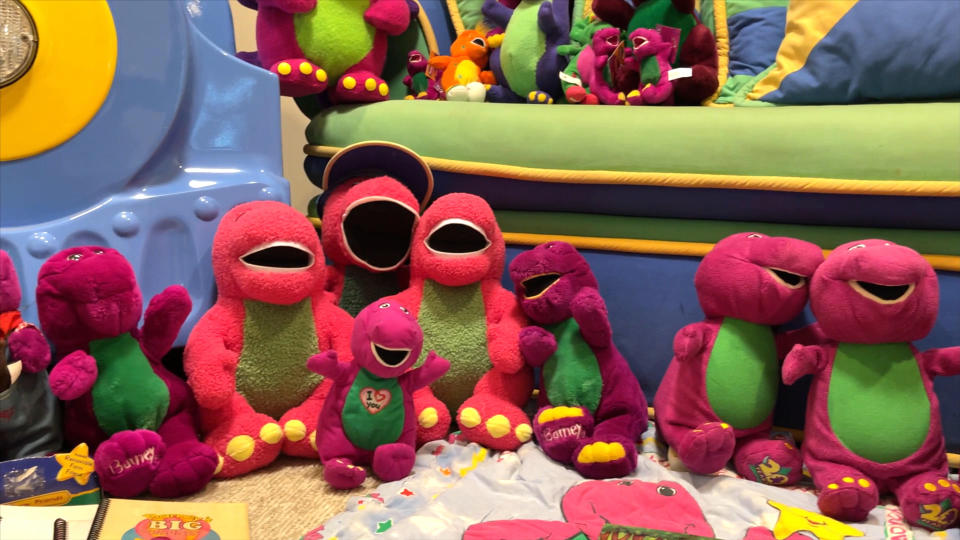 A collection of Barney plush toys