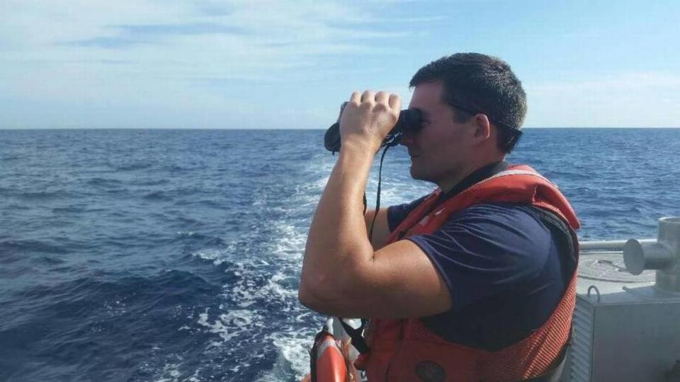 A U.S. Coast Guard crewman searches the water off Islamorada for signs of documentary filmmaker and conservationist Rob Stewart, who went missing diving the deep-water wreck of the Queen of Nassau.