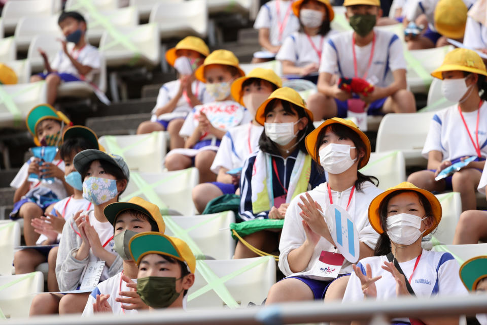 <p>Young fans wearing face masks enjoy the pre match atmosphere prior to the Men's First Round Group B match between New Zealand and Honduras on day two of the Tokyo 2020 Olympic Games at Ibaraki Kashima Stadium on July 25, 2021 in Kashima, Ibaraki, Japan. (Photo by Atsushi Tomura/Getty Images)</p> 