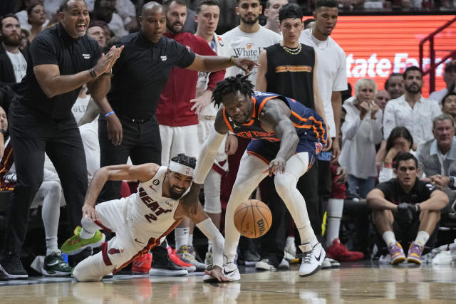 Miami Heat guard Gabe Vincent (2) and New York Knicks forward Julius Randle (30) battle for a loose ball during the second half of Game 6 of an NBA basketball second-round playoff series, Friday, May 12, 2023, in Miami. (AP Photo/Wilfredo Lee)