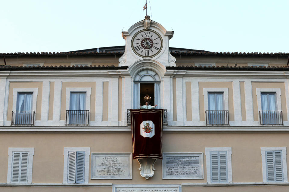 FILE - Pope Benedict XVI greets faithful from his summer residence of Castel Gandolfo, the scenic town where he spent his first post-Vatican days and made his last public blessing as pope, Feb. 28, 2013. Pope Emeritus Benedict XVI's death has hit Castel Gandolfo's "castellani" particularly hard, since many knew him personally, and in some ways had already bid him an emotional farewell when he uttered his final words as pope from the palace balcony overlooking the town square. (AP Photo/Luca Bruno, File)