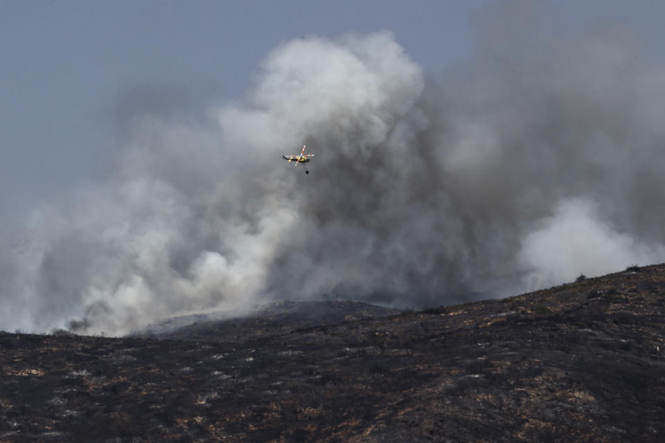 Clouds of smoke rise during a wildfire near Altura, eastern Spain, on Friday, Aug. 19, 2022. Up to early August, 43 large wildfires — those affecting at least 500 hectares (1,235 acres) — were recorded in the Mediterranean country by the Ministry for Ecological transition, while the average in previous years was 11. The European Forest Fire Information System estimates a burned surface of 284,764 hectares (704,000 acres) in Spain this year. That's four times higher than the average since records began in 2006. (AP Photo/Alberto Saiz)