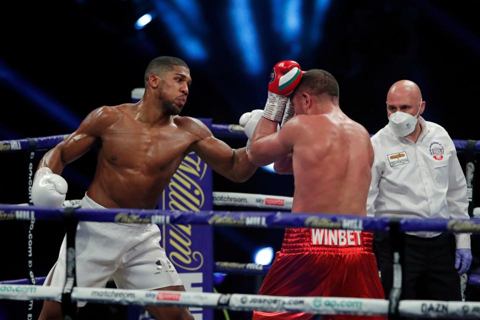 Britain's Anthony Joshua (L) lands a punch on Bulgaria's Kubrat Pulev (R) during their heavyweight world title boxing match at Wembley Arena in north west London on December 12, 2020. (Photo by ANDREW COULDRIDGE / POOL / AFP) (Photo by ANDREW COULDRIDGE/POOL/AFP via Getty Images)