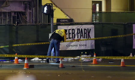 Las Vegas police investigate following a traffic crash in front of the Planet Hollywood Hotel, near the hotel and casino where the Miss Universe pageant was being held, in Las Vegas, Nevada December 20, 2015. REUTERS/David Becker