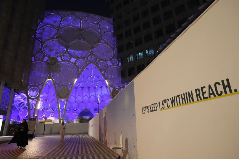 A sign near Al Wasl Dome at Expo City reads "let's keep 1.5 degrees Celsius within reach" at COP28.