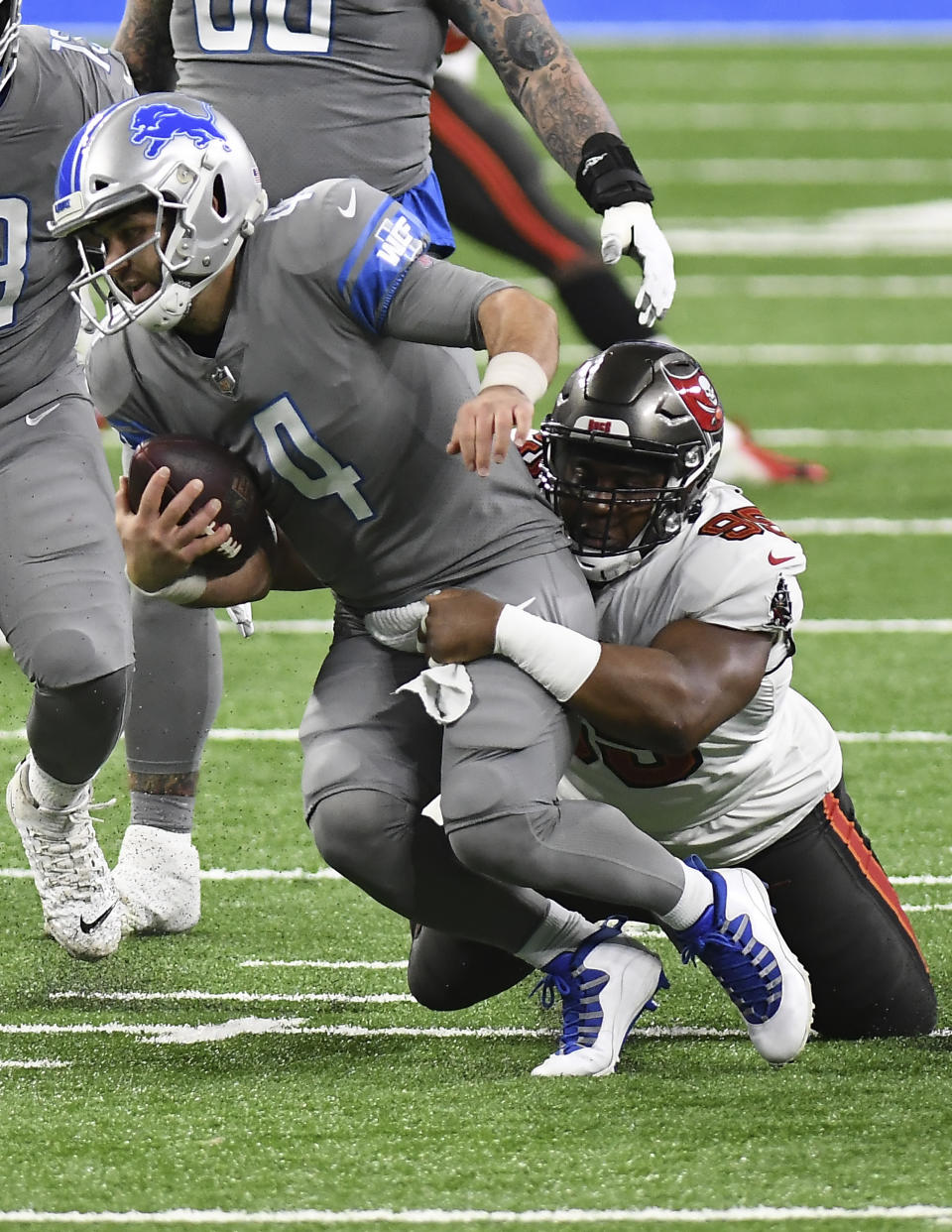 Detroit Lions quarterback Chase Daniel (4) is sacked by Tampa Bay Buccaneers' Jaydon Mickens (85)during the first half of an NFL football game, Saturday, Dec. 26, 2020, in Detroit. (AP Photo/Lon Horwedel)