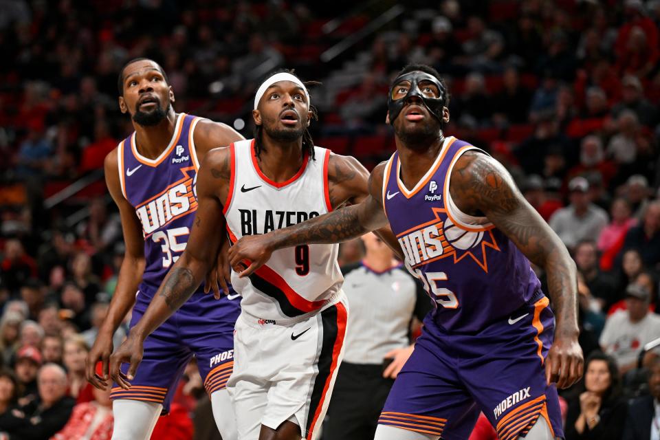 Jerami Grant #9 of the Portland Trail Blazers, Kevin Durant #35 and Nassir Little #25 of the Phoenix Suns eye the ball during the first quarter of the game at Moda Center on Dec. 19, 2023 in Portland, Oregon. NOTE TO USER: User expressly acknowledges and agrees that, by downloading and/or using this photograph, User is consenting to the terms and conditions of the Getty Images License Agreement. (Photo by Alika Jenner/Getty Images)