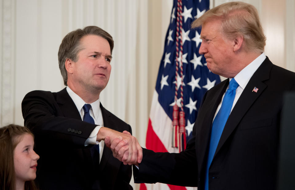 Judge Brett Kavanaugh shakes hands with President Donald Trump after the announcement of his nomination to the Supreme Court in the East Room of the White House on Monday. (SAUL LOEB/AFP/Getty Images)