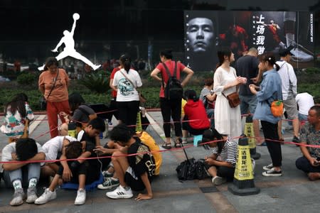 FILE PHOTO: People queue outside a Nike's Air Jordan store before the new Air Jordan 1 sneakers go on sale in Yichang, Hubei