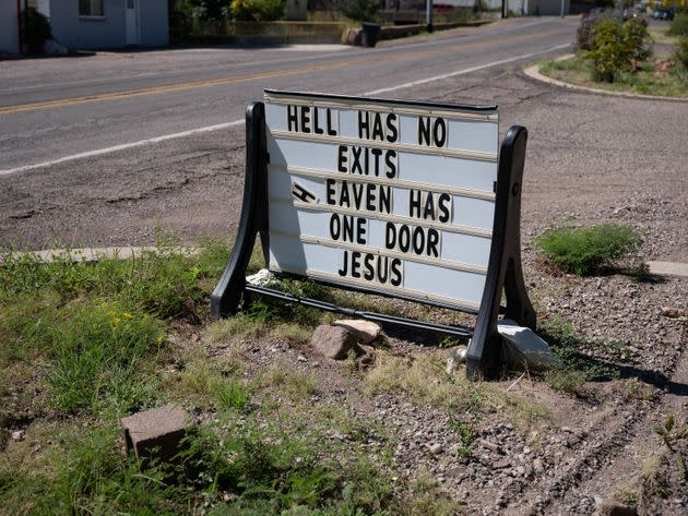 Along a road in Clifton, Arizona, a sign depicts a Christian message for passers-by. (Photo: Molly Peters for HuffPost)