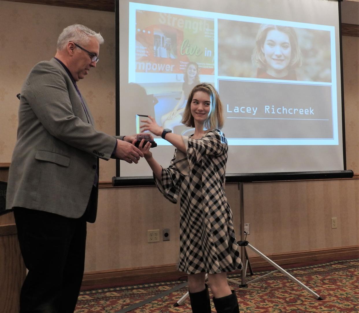 Steve Oster, Superintendent for Coshocton County Board of DD, presents the Individual Spotlight Award to Lacey Richcreek Wednesday at the Developmental Disabilities Luncheon at Coshocton Village Inn and Suites. Richcreek was acknowledge for all she does despite having cerebral palsy.