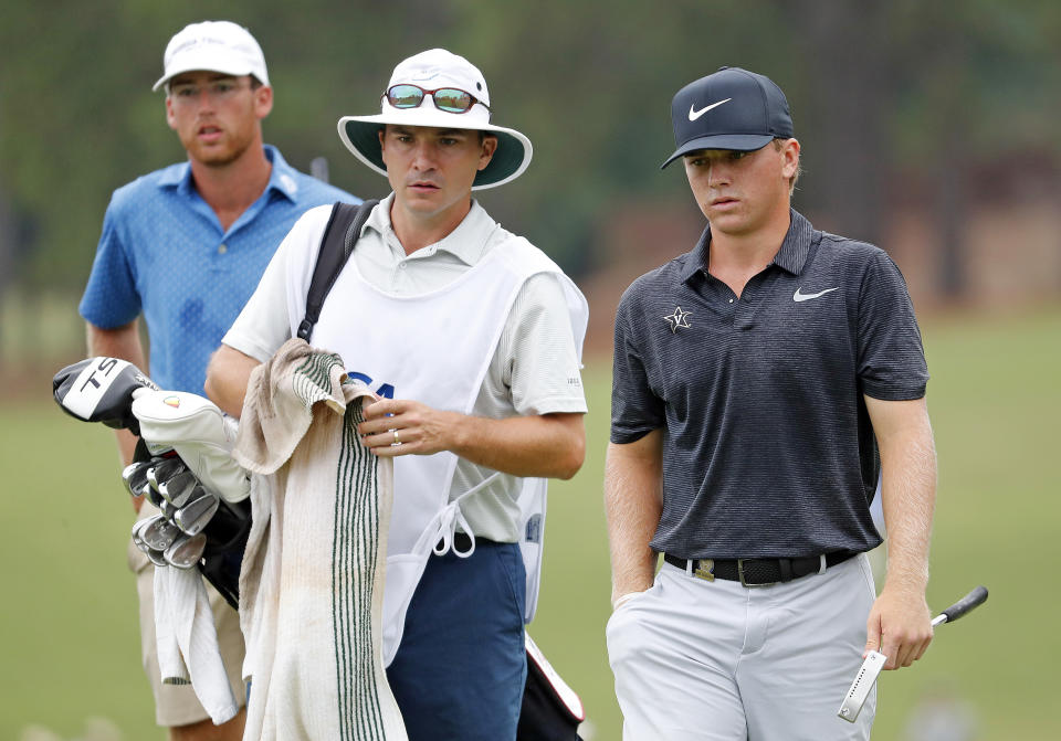 John Augenstein walks up to the green with his caddy during the final round against Andy Ogletree, at the USGA Amateur Golf Championship at the Pinehurst Country Club , in Pinehurst, N.C, Sunday, Aug. 18, 2019, (AP Photo/Karl B DeBlaker)