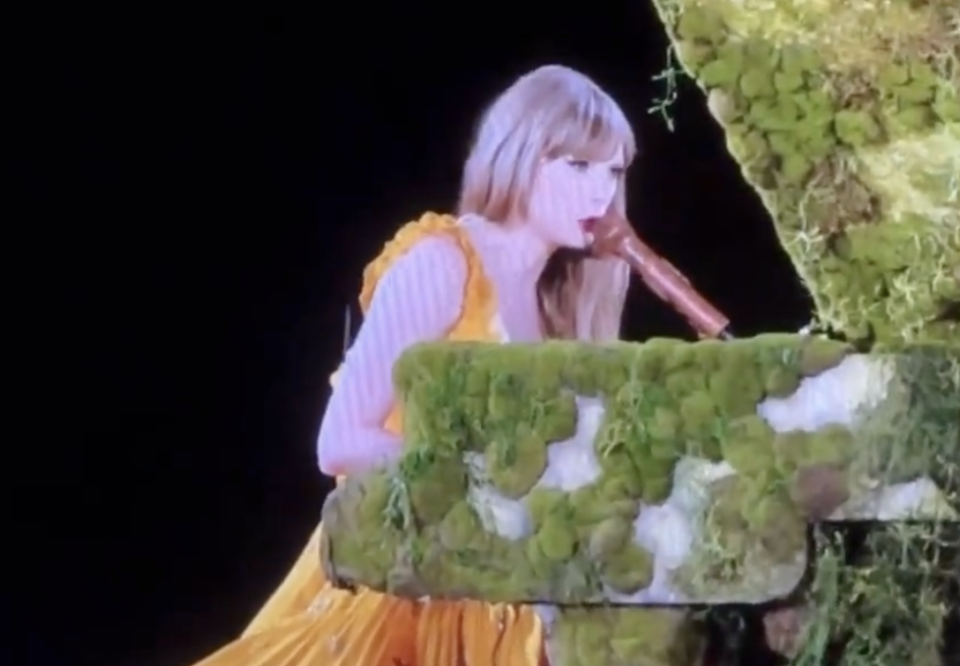 Close-up of Taylor performing onstage at a piano