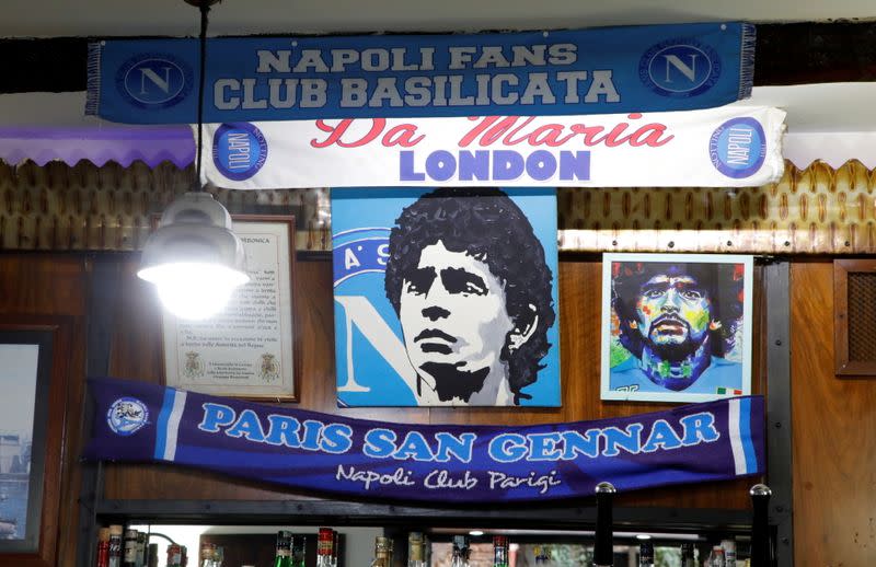Posters depicting late soccer legend Diego Maradona are pictured the day after his death in Naples