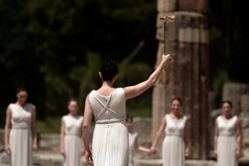 Actress Ino Menegaki, playing the high priestess, holds the Olympic flame during the torch lighting ceremony in ancient Olympia, Greece, on May 10. The ceremony signals the final countdown to the start of this year's summer Games in London