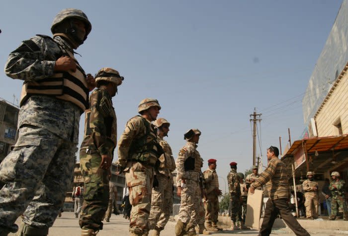 Demonstrators pass through a security checkpoint before a rally at Firdos square in Baghdad on November 21, 2008. Followers of Shiite cleric Moqtada al-Sadr marched on Friday against a pact letting U.S. forces stay in Iraq until 2011. File Photo by Ali Jasim/UPI