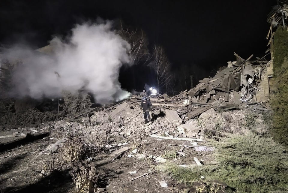 In this photo provided by the Zaporizhzhia region military administration, Ukrainian firefighters work at damaged hospital maternity ward in Vilniansk, Zaporizhzhia region, Ukraine, early Wednesday, Nov. 23, 2022. An overnight rocket attack struck a hospital maternity ward in southern Ukraine, killing a newborn baby, Ukrainian authorities said Wednesday. The baby's mother and a doctor were pulled alive from the rubble. The region's governor said the rockets were Russian. (Zaporizhzhia region military administration via AP)