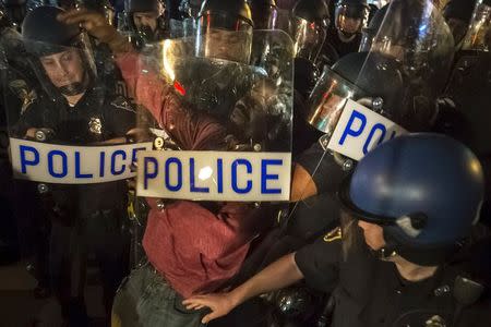 A man, protesting the death of Freddie Gray, is detained by police after defying a curfew in Baltimore, Maryland April 30, 2015. REUTERS/Adrees Latif