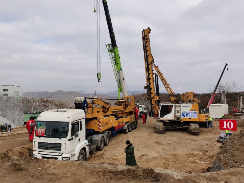 Rescuers are seen at the site where workers were trapped underground after an explosion at the gold mine under construction, in Qixia