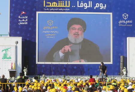 Lebanon's Hezbollah leader Sayyed Hassan Nasrallah gestures as he addresses his supporters from a screen during a rally, in Mashghara village in the Bekaa Valley, Lebanon April 15, 2018. REUTERS/Aziz Taher