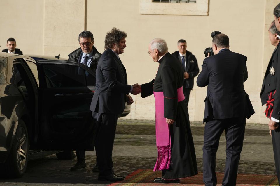 Argentine President Javier Milei, left, is welcomed by the head of the Papal Household, Bishop Leonardo Sapienza in the St. Damasus Courtyard at The Vatican as he arrives for a private audience with Pope Francis, Monday, Feb. 12, 2024. Milei, who will meet Italian President Sergio Mattarella and Italian Premier Giorgia Meloni later in the day, attended the canonization of the first Argentine female saint, María Antonia de Paz y Figueroa also known as "Mama Antula" in St. Peter's Basilica on Sunday. (AP Photo/Alessandra Tarantino)