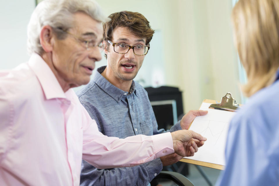 Three people going over plans