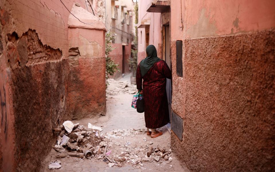 A woman enters a damaged building inside the Medina following a powerful earthquake in Marrakesh