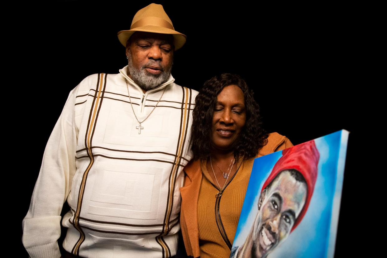 Rodney and RowVaughn Wells, the parents of Tyre Nichols, look down at a painting of their son as they pose for a portrait in Memphis, Tenn., on Thursday, January 11, 2024.