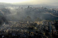 FILE - Smoke raises from burnt-out houses after a wildfire reached Villa Independencia neighborhood in Vina del Mar, Chile, Feb. 3, 2024. Scientists say climate change creates conditions that make the drought and wildfires now hitting South America more likely. (AP Photo/Esteban Felix, File)