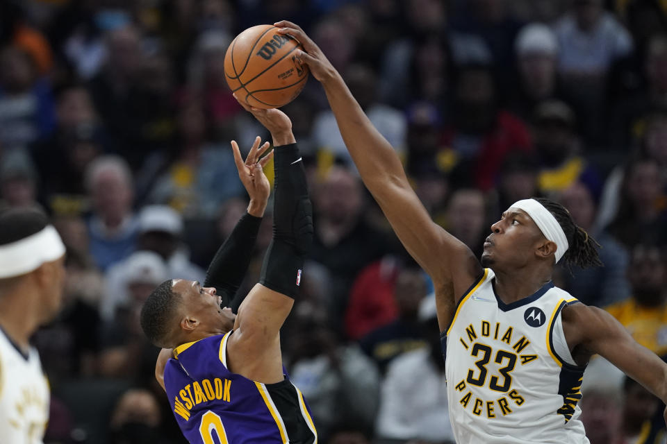 Indiana Pacers' Myles Turner (33) blocks the shot of Los Angeles Lakers' Russell Westbrook (0) during the second half of an NBA basketball game Wednesday, Nov. 24, 2021, in Indianapolis. (AP Photo/Darron Cummings)