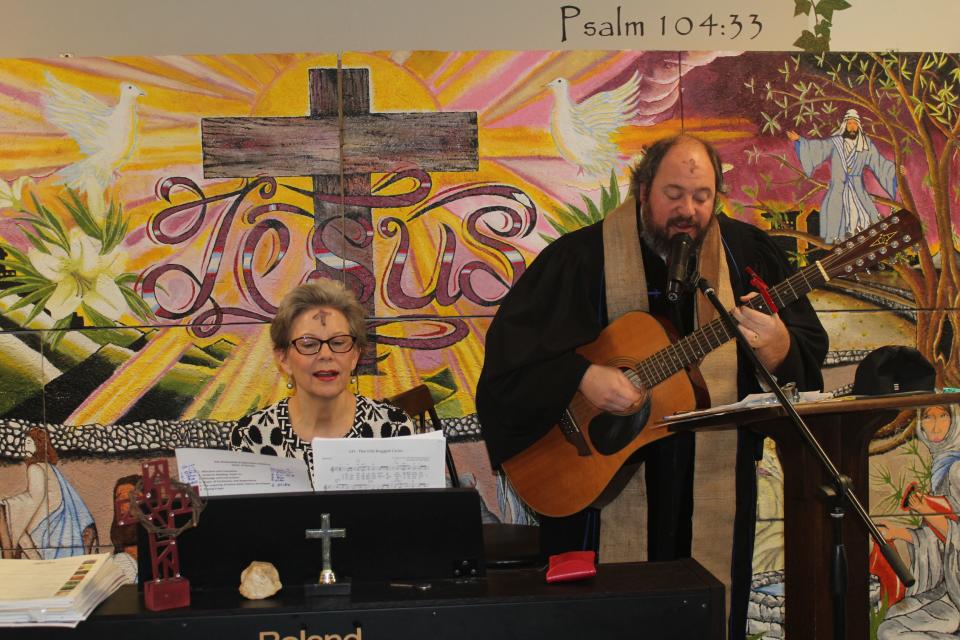 The Rev. Rob James of First Baptist Church on Anderson Street plays and sings. Eight pastors from seven Christian denominations held an Ash Wednesday service on Feb. 22, 2023, at Operation Inasmuch, a downtown nonprofit in Fayetteville, NC, that serves the homeless and people in need.