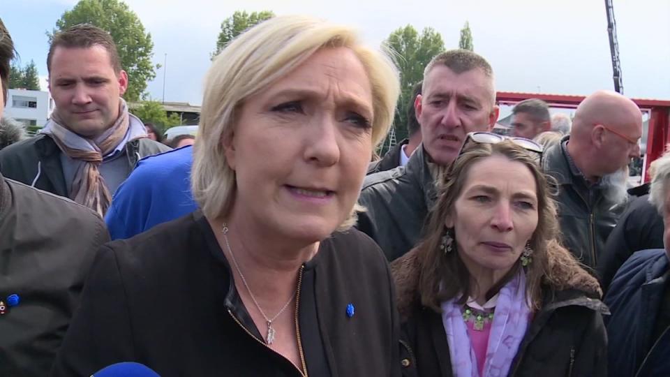 Far-right French presidential candidate Marine Le Pen is greeted by workers outside a whirlpool home appliance factory in Amiens, France, Wednesday April 26, 2017.