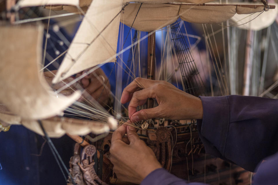 Malagasy women build a model ship at the Le Village model ship making company in Antananarivo, Madagascar, Wednesday, Sept. 11, 2024. (AP Photo/Alexander Joe)