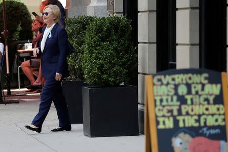 Clinton, 68, was taken to her daughter Chelsea's home in Manhattan, and emerged later wearing sunglasses and telling reporters that she was "feeling great," around two hours after she left the event on a hot and muggy morning. REUTERS/Brian Snyder