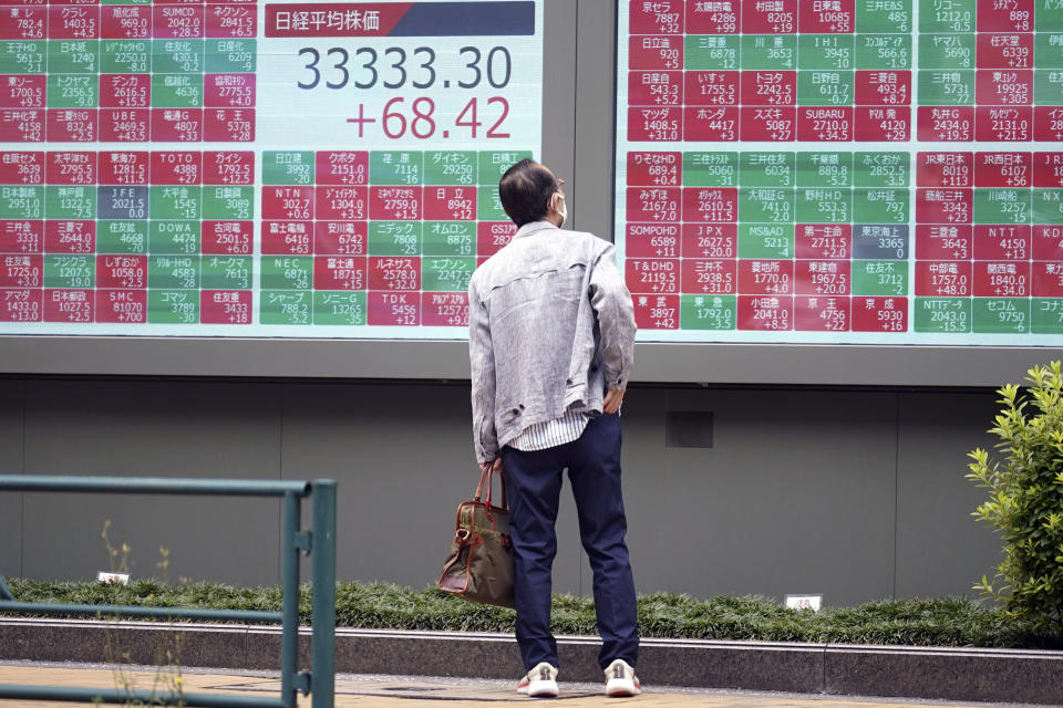 A person looks at an electronic stock board showing Japan's Nikkei 225 index at a securities firm Friday, June 23, 2023, in Tokyo. Asian shares sank sharply Friday after several central banks around the world cranked interest rates higher in their fight against inflation.(AP Photo/Eugene Hoshiko)