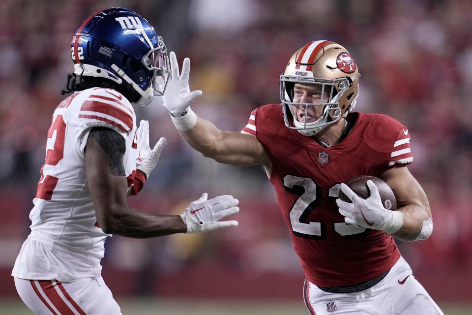 San Francisco 49ers running back Christian McCaffrey, right, runs against New York Giants cornerback Adoree' Jackson during the second half of an NFL football game in Santa Clara, Calif., Thursday, Sept. 21, 2023. (AP Photo/Godofredo A. Vásquez)