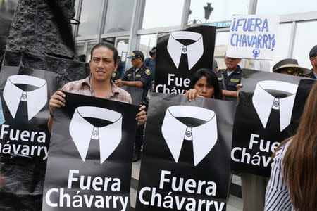 People hold placards reading "Chavarry out" referring to Peru Attorney General Pedro Chavarry, during a protest outside the Attorney General's Office in Lima, Peru, January 8, 2019. REUTERS/Mariana Bazo