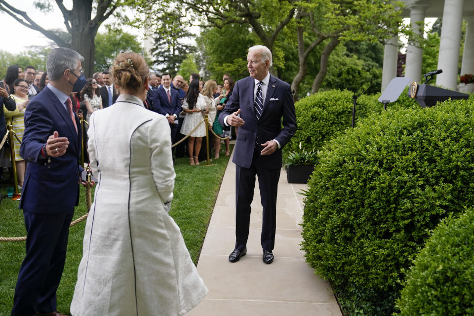 President Joe Biden waits to escort Mexico's first lady Beatriz Gutierrez Muller to the White House after speaking during a Cinco de Mayo event in the Rose Garden of the White House, Thursday, May 5, 2022, in Washington. (AP Photo/Evan Vucci)