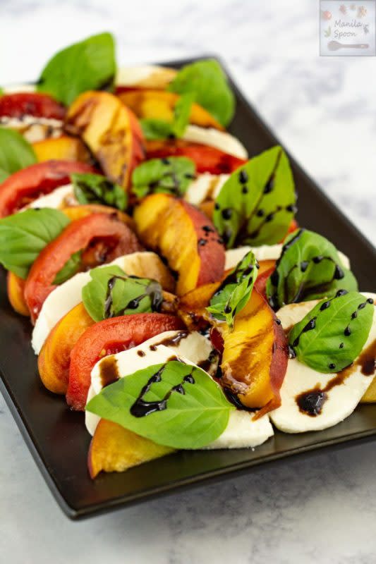 <p>Manila Spoon</p><p>Such an easy, tasty and summer salad loaded with delightful flavors from fresh peaches, mozarella, basil, tomatoes and balsamic dressing! </p><p><strong>Get the Recipe: <a href="https://www.manilaspoon.com/2019/08/easy-peach-caprese-salad.html" rel="nofollow noopener" target="_blank" data-ylk="slk:Peach Caprese Salad;elm:context_link;itc:0;sec:content-canvas" class="link ">Peach Caprese Salad</a></strong></p>