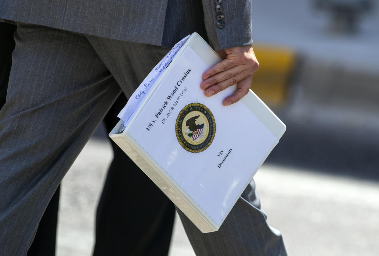 Federal prosecutor Ian Martinez Hanna holds a Victim Impact Statement documents binder while walking outside court for a lunch break on the second day of the sentence hearing of mass shooter Patrick Crusius in El Paso, Texas, Thursday, July 6, 2023. Nearly four years after a white gunman killed 23 people at a Walmart in El Paso in a racist attack that targeted Hispanic shoppers, relatives of the victims are packing a courtroom near the U.S.-Mexico border this week to see Crusius punished for one of the nation's worst mass shootings. (AP Photo/Andrés Leighton)