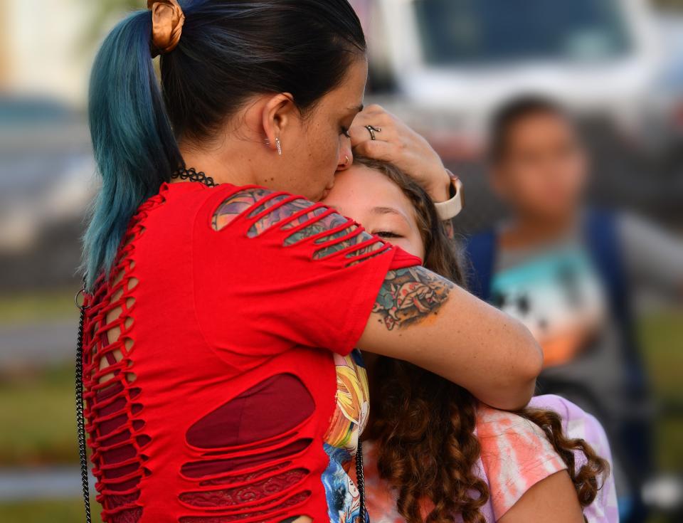 Caitlin Leeds gives her daughter Avalynn Leeds a big hug before she went on to class. Avalynn is a 5th grader at Coquina Elementary School in Titusville.