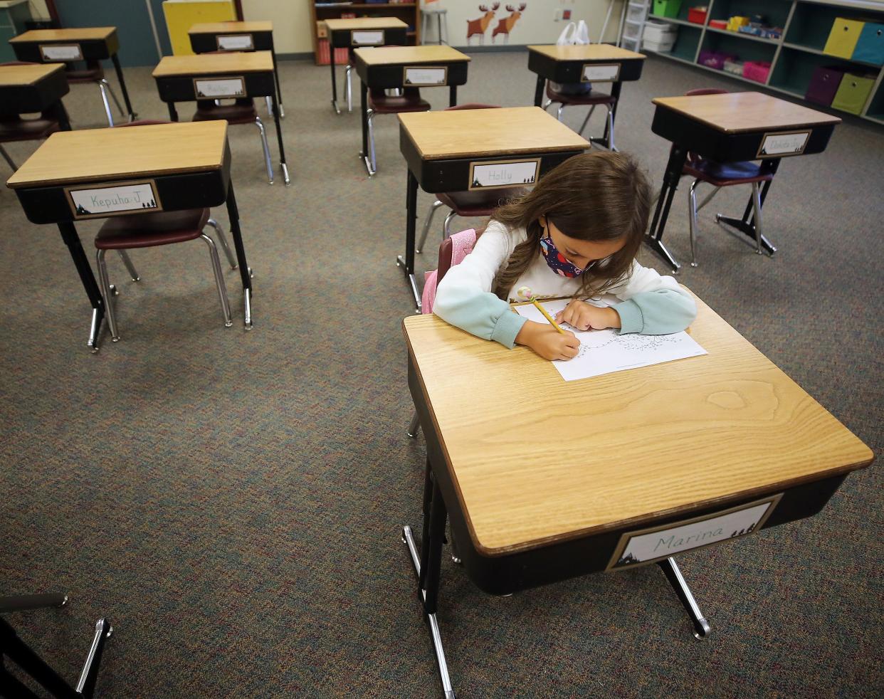 FILE — Second-grader Marina Fleming connects the dots to create a unicorn on the first day of school at View Ridge Elementary Arts Academy in Bremerton on Sept. 1. The Bremerton School District is studying changes to the school calendar that could lead to a shorter summer break in future school years.