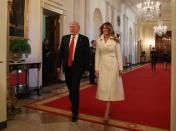 <p>The First Lady arrives at the Women's History Month event hosted at The White House. She dressed for the occasion in white - a color of the women's suffrage movement - modeling a coat by The Row. She completes the outfit with a pair of Christian Louboutin heels.</p>