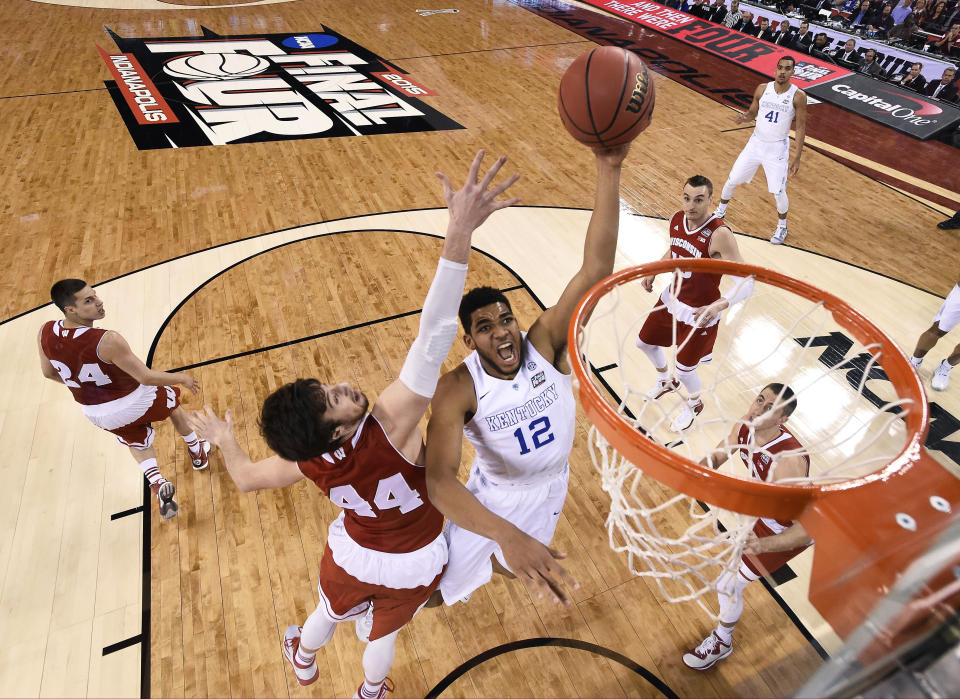 FILE - Kentucky's Karl-Anthony Towns (12) drives to the basket past Wisconsin's Frank Kaminsky (44) during the first half of the NCAA Final Four national semifinal college basketball game in Indianapolis, April 4, 2015. (Chris Steppig/NCAA Photos via AP, Pool, File)