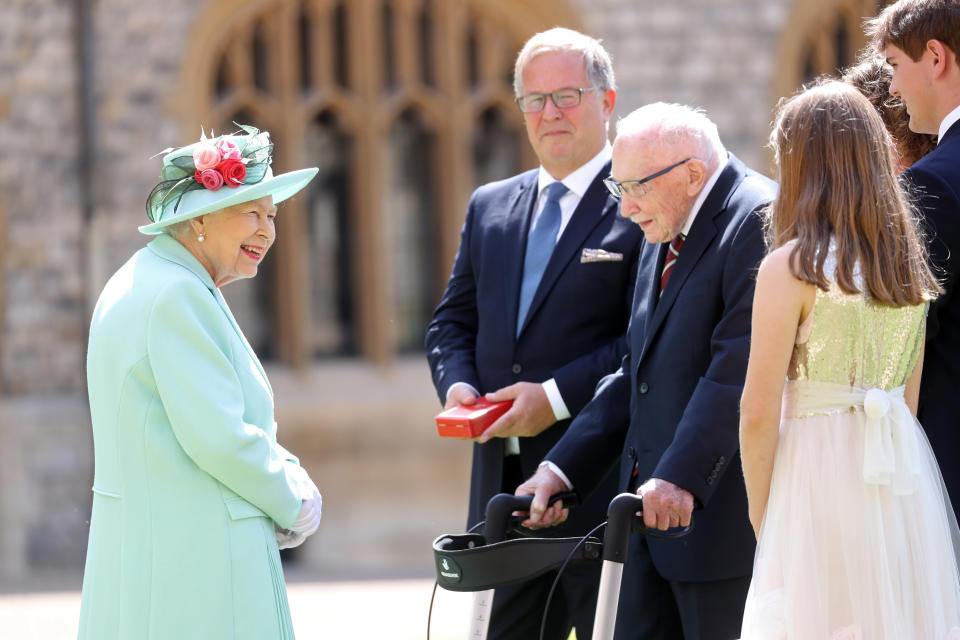 WINDSOR, ENGLAND - JULY 17: Queen Elizabeth II talks Captain Sir Thomas Moore and his family after awarding him with the insignia of Knight Bachelor at Windsor Castle on July 17, 2020 in Windsor, England. British World War II veteran Captain Tom Moore raised over £32 million for the NHS during the coronavirus pandemic.  (Photo by Chris Jackson/Getty Images)